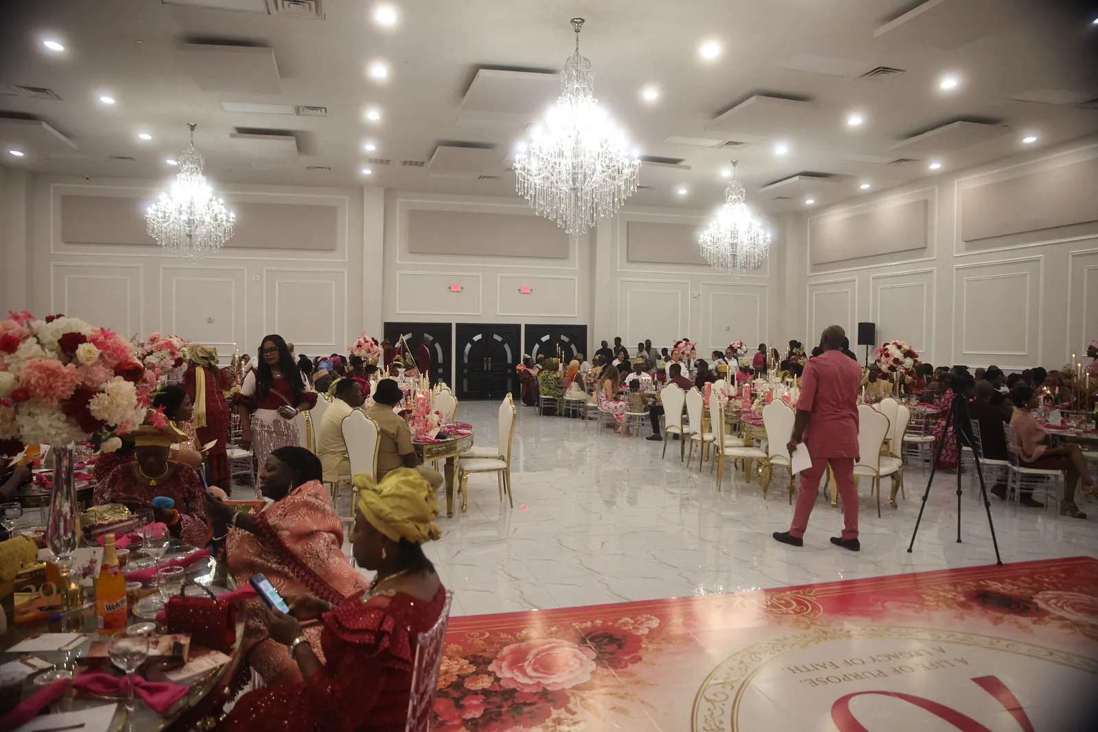 A full room of guests seated for a large celebration