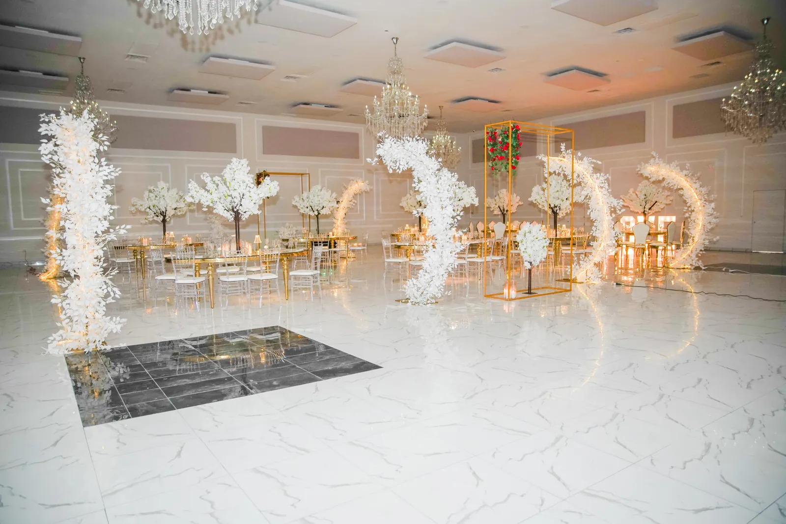 Wide view of the hall dressed in white with a dance floor at the centre